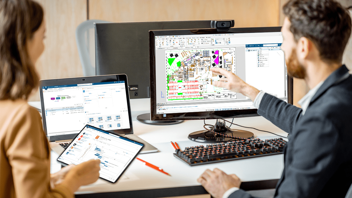 A Guy explaining a cad design drawing on a monitor to a woman holding a tablet
